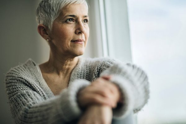 woman looking out window