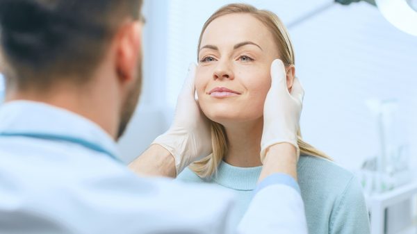 Woman being examined by plastic surgeon